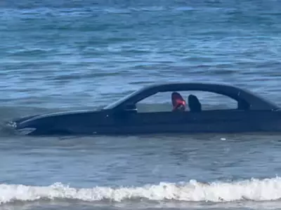 BMW parked on beach 