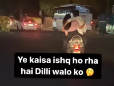 Couple Hugs While Riding Scooter In Delhi