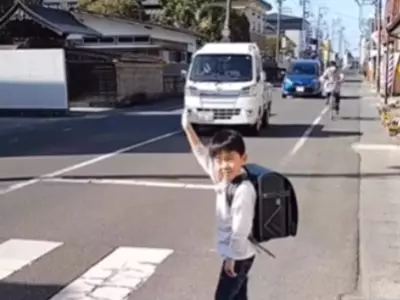 Little Boy Bows Thank You After Crossing Road In Japan