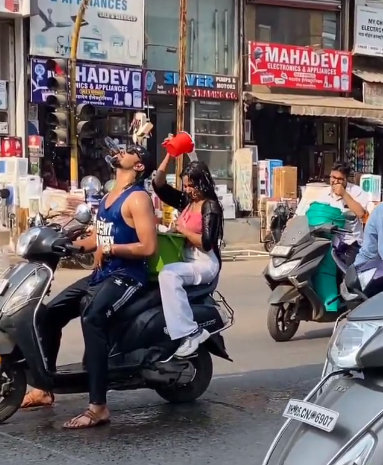 man and woman bathe on scooter 