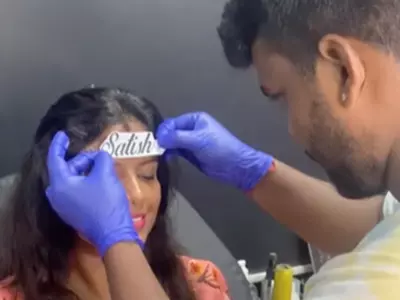 Woman Tattoos Husband's Name On Forehead