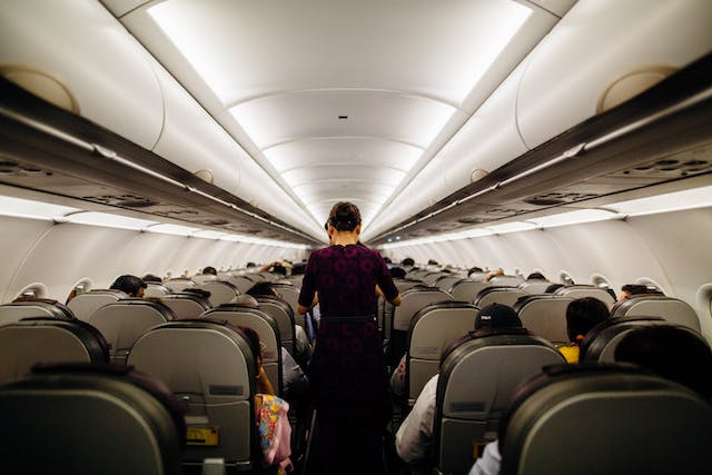 Passenger adopts a strange sleeping position on a plane