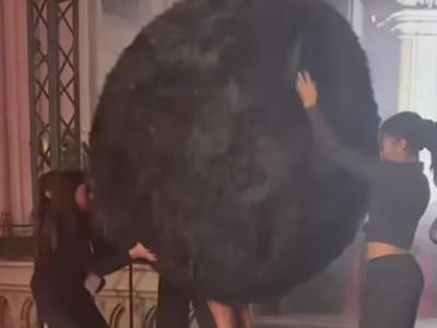 model dressed as a giant furball
