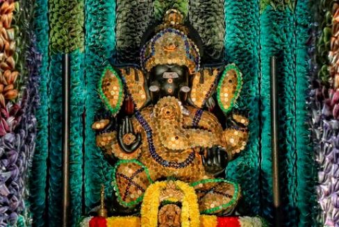 Sri Sathya Sai Ganapathy temple decorated with coins and notes/ PTI