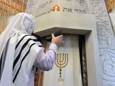 A Rabbi blows the Shofar in a synagogue on Yom Kippur