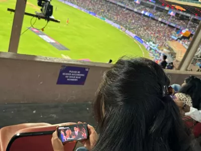 Girls Watching Friends On Their Phones At Stadium During IPL Match