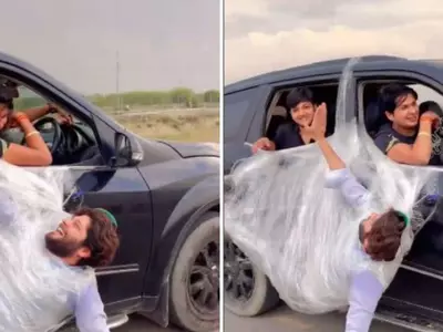 With Plastic Wrap, A Man Hangs From A Moving Car's Door, Video Has Been Viewed 92 Million Times
