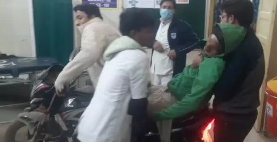 An Ailing Grandfather Is Accompanied By A Man On A Bike Inside A Hospital 