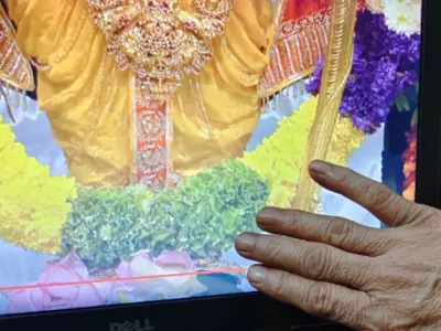 An Image Of His Mother Seeking Blessings From Ram Lalla Is Shared Through A Laptop Screen By A Man
