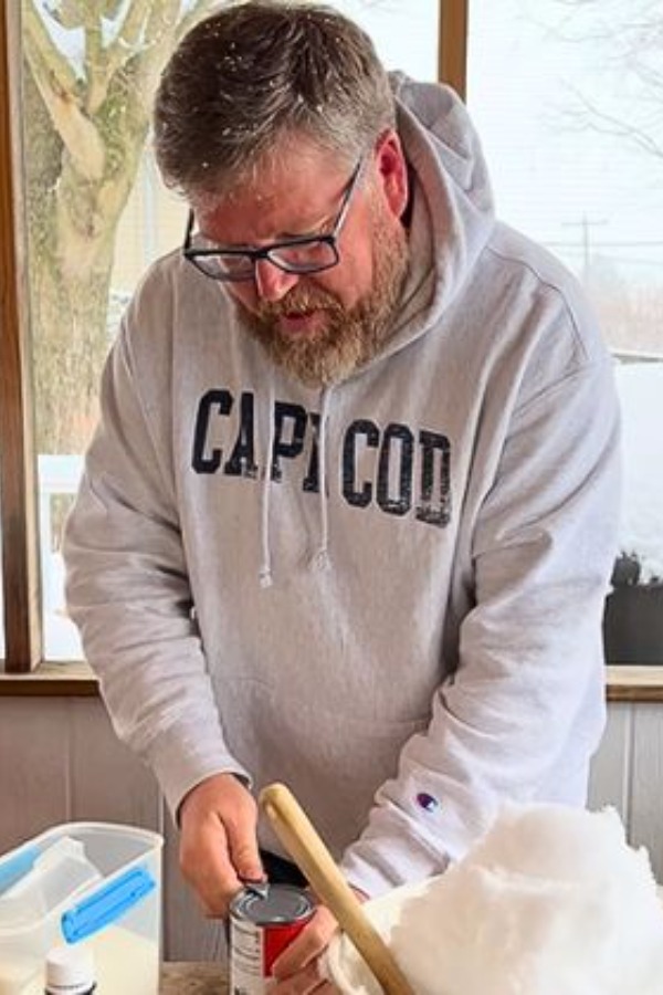 Man uses snow outdoors to create ice cream