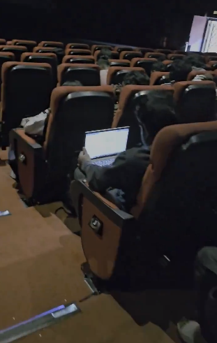 The video shows the highlight of the day in Bengaluru as a man works on a laptop in the cinema hall