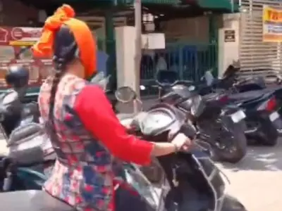 A Bengaluru Woman Gets Slammed For Using Her Phone On A Scooter
