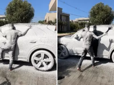 Internet Loves A Man Who Sprays White Paint On A Car While Another Stands On It Like A Statue