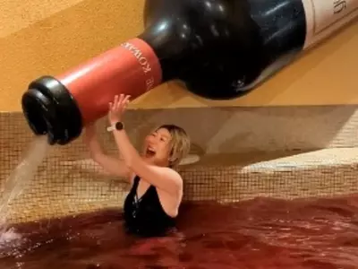 It Is A Japanese Amusement Park With A Red Wine Pool
