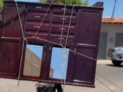 Man transports huge wardrobe on bike