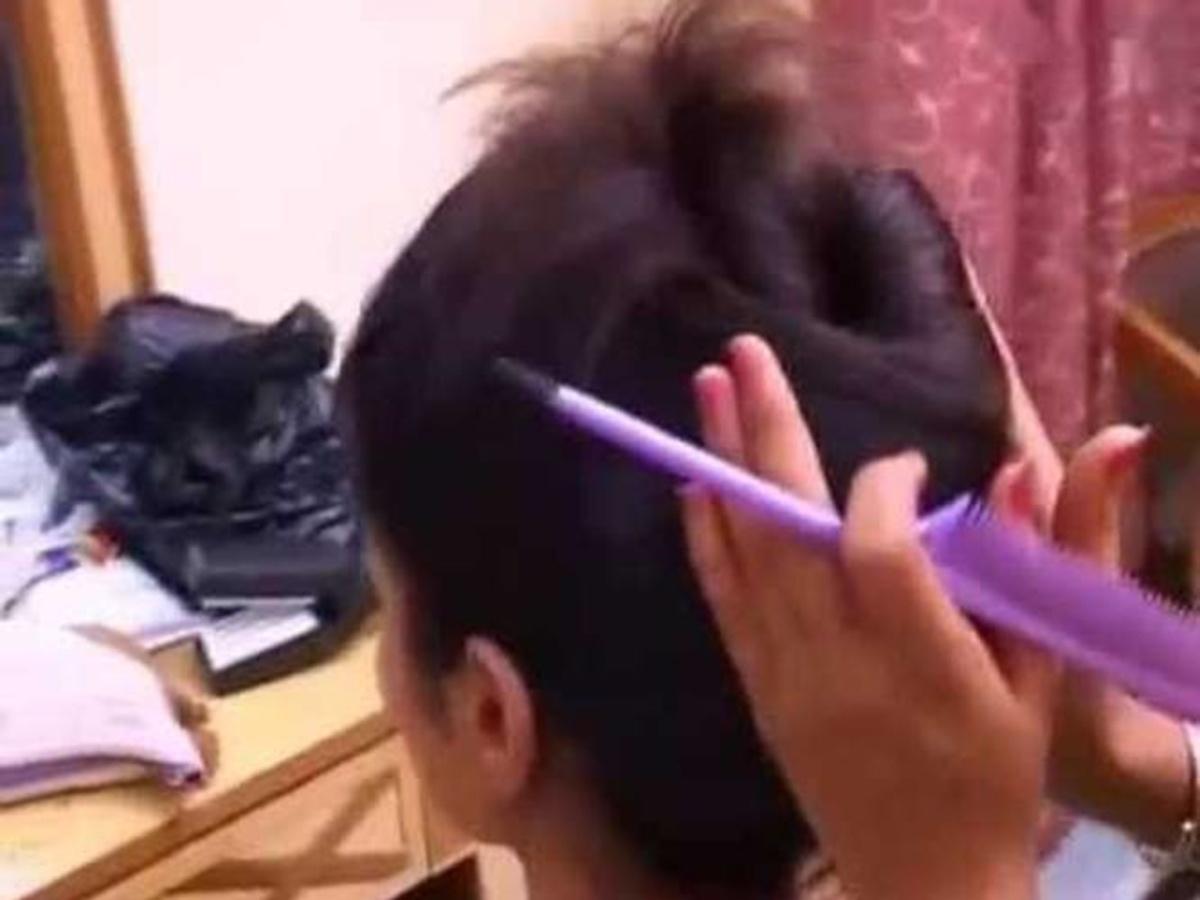 Beautiful Indian Long Hair Girl Demonstrating Bun Hair Style Beautiful Indian Long Hair Girl Demonstrating Bun Hair Style
