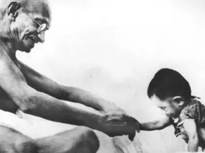 Gandhiji playing with a kid