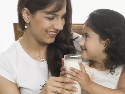 mom and daughter drinking milk