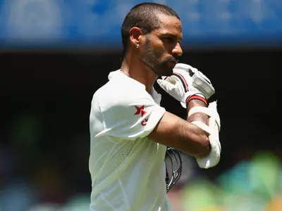 Dhawan out