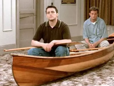 Joey and Chandler sitting on a boat
