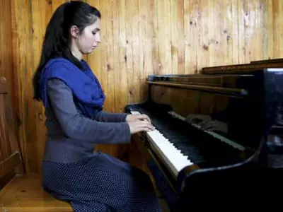 Afghan Teenager Braves Threats, Family Pressure To Lead Women's Orchestra