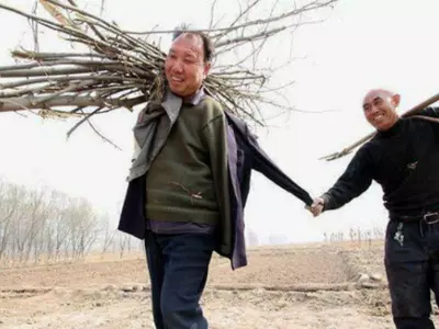 Two disabled men planting trees