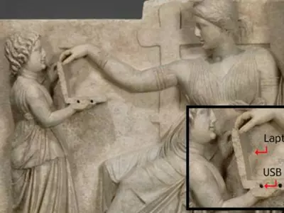 Conspiracy Theorists Claim A Young Girl Is Holding A Laptop In A 2500-Year-Old Greek Statue!