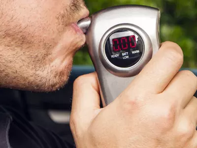 Drunk Driver Vrooms Away, Breathalyzer In Lips