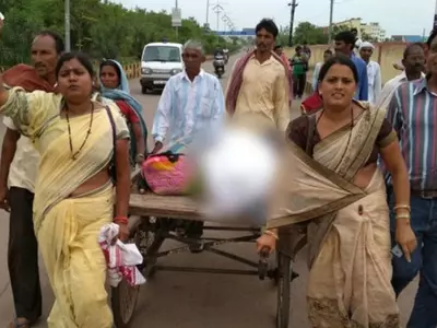 body of a girl carried in a hand cart