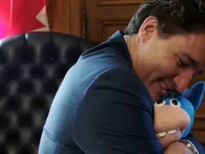 Justin Trudeau hugs a puppet unicorn