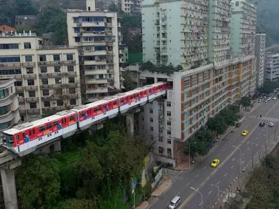 Train in China goes through a block of flats