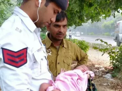 Delhi Traffic Police Officials Save Life Of A Female Infant Found Abandoned & Surrounded By Dogs In
