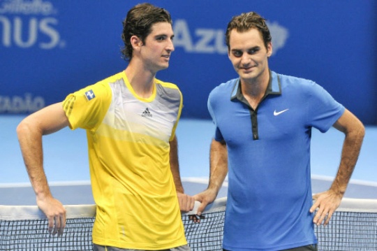 Thomaz Bellucci of Brazil and Roger Federer of Switzerland