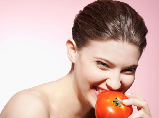 girl eating tomatoe
