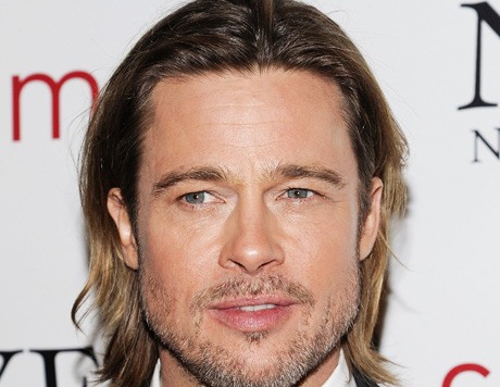 Brad Pitt trips while carrying daughter