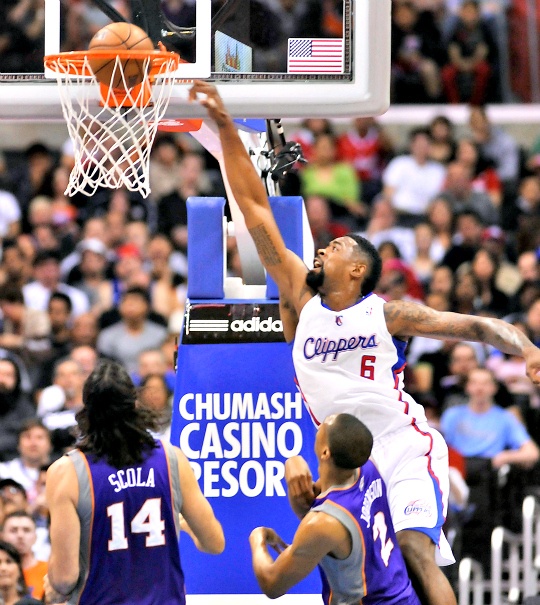 Los Angeles Clippers center DeAndre Jordan (6) throws down a dunk in front of Phoenix Suns forward Luis Scola (14), of Argentina, and forward Wesley Johnson (2)