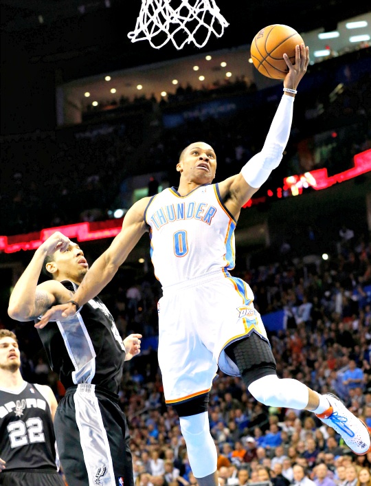 Oklahoma City Thunder guard Russell Westbrook (0) shoots in front of San Antonio Spurs guard Danny Green (4) in the first quarter of an NBA basketball game in Oklahoma City, 