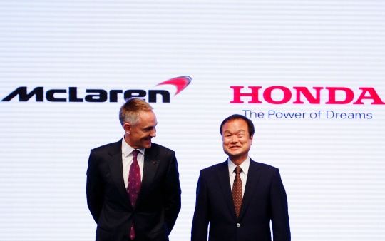 Honda Motor Co's President and Chief Executive Officer Takanobu Ito (R) exchanges smiles with with McLaren Group Limited CEO Martin Whitmarsh at their joint news conference in Tokyo