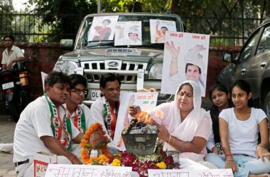 ndia's Congress party workers perform a Yagya for their party