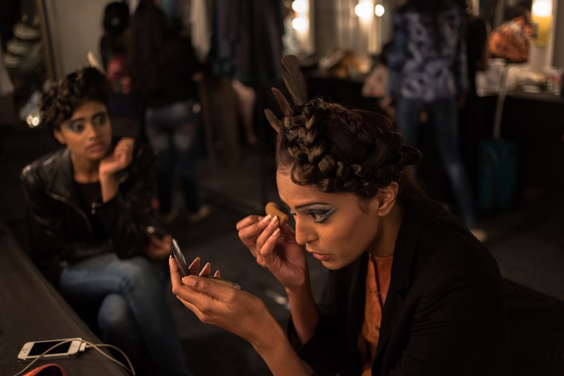 A model applies makeup backstage during the Wills Lifestyle India Fashion Week