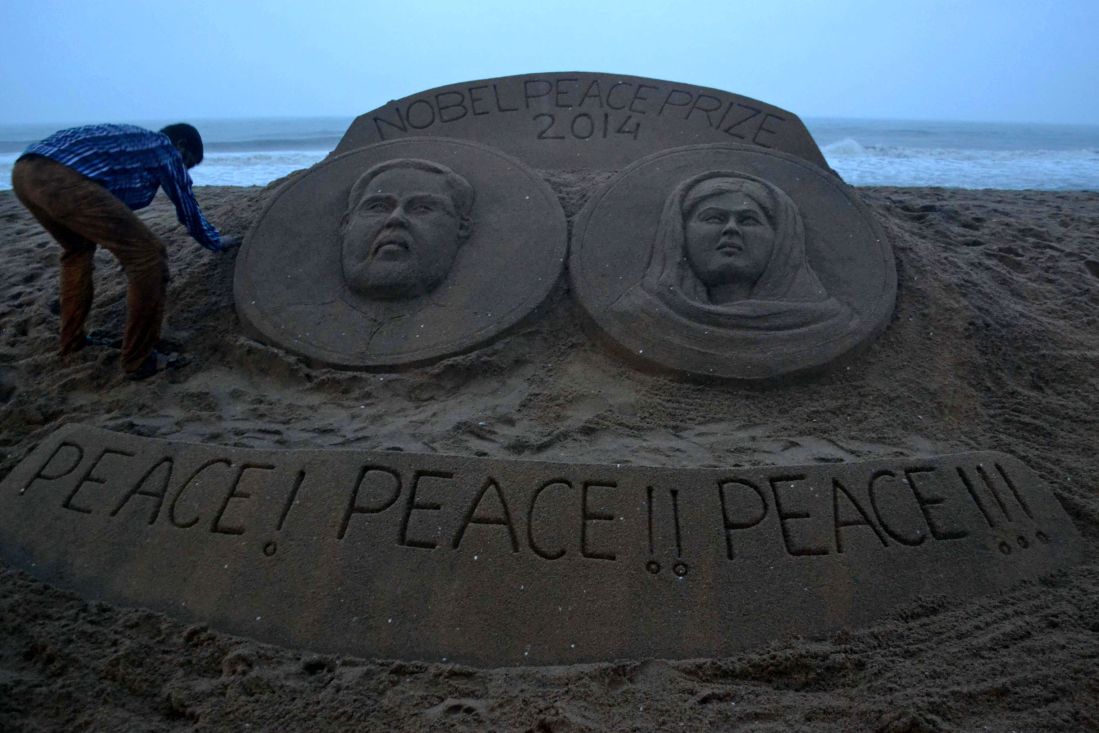 Sand sculpture bearing portraits of Kailash Satyarthi and Malala Yousafzai 