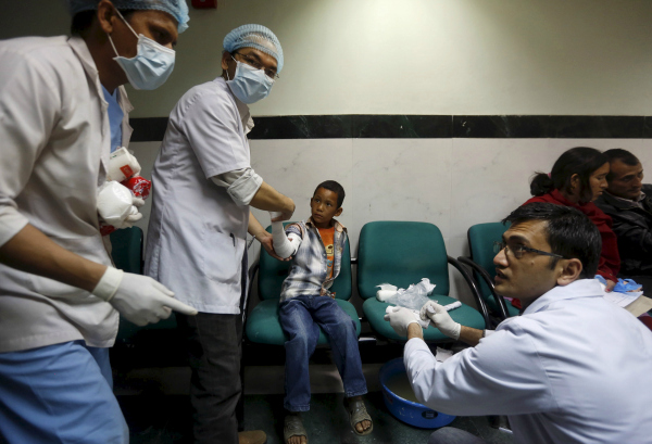 Doctors attend to a young boy in a trauma center in Kathmandu