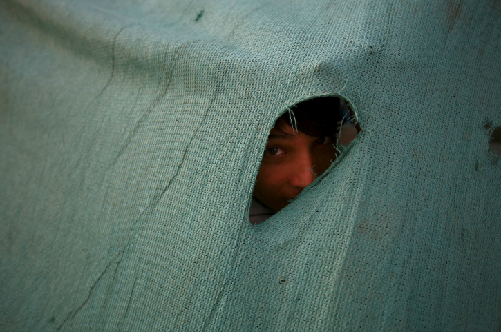 child peeping through tent 