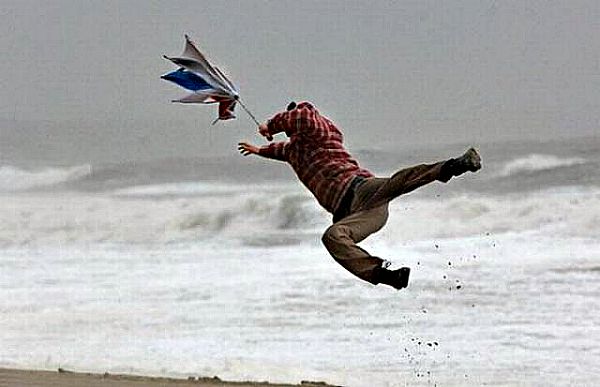 man flying in strong storm