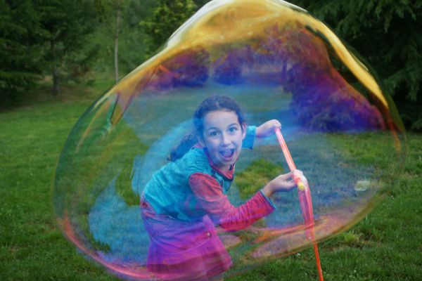 girl playing with a bubble
