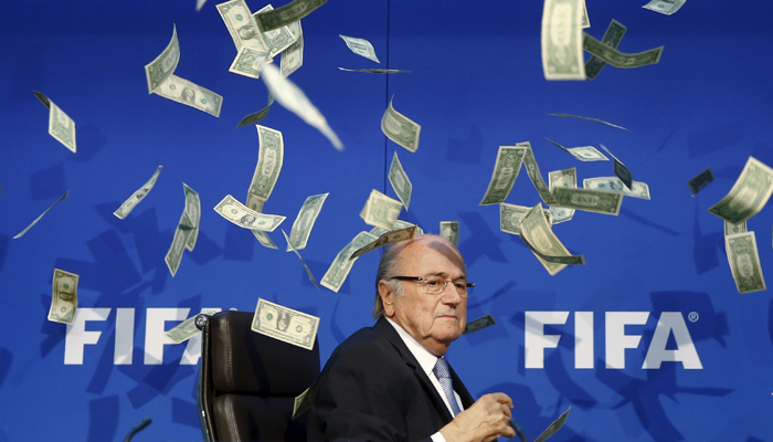 A British comedian rained fake dollar notes on Sepp Blatter.