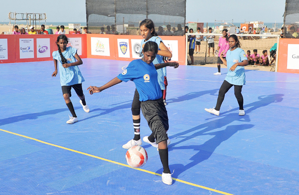 girls playing slum soccer tournament