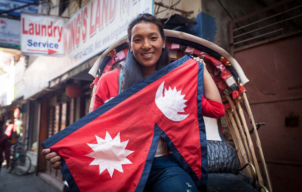 A Nepalese woman with the national flag