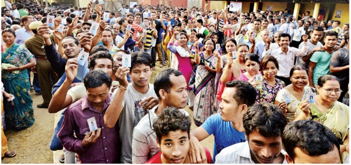 Voters lining up to vote in a polling station in Assam