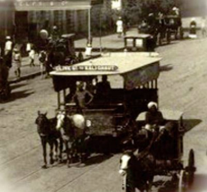 Shepherds herd their goats as a tram passes in the background at the  ´Maidan´ (open ground) in Kolkata (Calcutta), West Bengal, India. Started  by the  - SuperStock